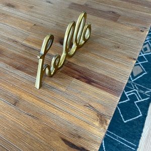 Brass “hello” sculpture.